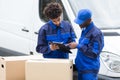 Delivery Man Writing On The Clipboard Royalty Free Stock Photo