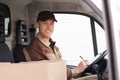 Delivery Man Writing On Clipboard In Truck Royalty Free Stock Photo