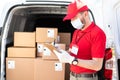 Delivery man writing a customer information before delivering a parcel Royalty Free Stock Photo