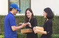 Delivery man asking woman to sign mobile for the delivery