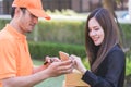 Delivery man asking woman to sign mobile for the delivery