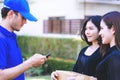 Delivery man asking woman to sign mobile for the delivery