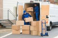 Delivery Men Unloading Boxes On Street Royalty Free Stock Photo