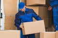 Delivery Men Unloading Boxes On Street Royalty Free Stock Photo