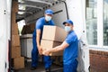 Delivery Men Unloading Cardboard Boxes Royalty Free Stock Photo