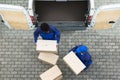 Delivery Men Unloading The Cardboard Boxes Royalty Free Stock Photo