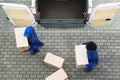 Delivery Men Unloading The Cardboard Boxes Royalty Free Stock Photo