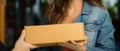 Delivery moment Woman receives parcel boxes from courier at home