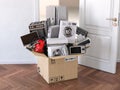 Delivery, moving and online shopping concept. Home household kitchen appliances in open cardboard box in front of open door