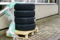 Delivery of a new set of winter tires to the tire shop, placed on a pallet Royalty Free Stock Photo