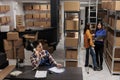 Delivery operators managing warehouse product audit in storage room Royalty Free Stock Photo