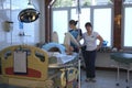 At the delivery room. Woman giving birth lying in the chair, doctors ready to deliver baby