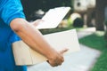 Delivery service courier in front of the house. Royalty Free Stock Photo