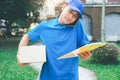 Delivery service courier standing in front of the house with box Royalty Free Stock Photo