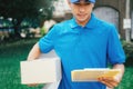 Delivery service courier standing in front of the house with boxes Royalty Free Stock Photo