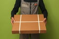 a delivery service employee holds a box