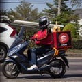 Delivery service man ride a Motercycle of Pizza Hut Company Royalty Free Stock Photo