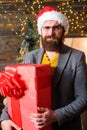 Delivery service. Man santa hat hold gift. Christmas spirit is here. Spread happiness and joy. Bearded guy wear santa