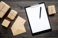 Delivery service office with cardboard box and letters for courier on wooden background top view mock-up Royalty Free Stock Photo