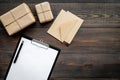 Delivery service office with cardboard box and letters for courier on wooden background top view mock-up Royalty Free Stock Photo