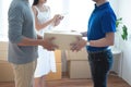 Delivery service worker in uniform delivering parcels to happy asian couple. Woman with tablet signing proof document.shopping