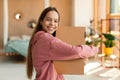 Delivery and shopping. Excited teen customer girl hugging cardboard box and smiling, receiving new clothes from store