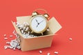 delivery time of the parcel. open box with alarm clock on a red background. 3D render