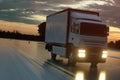 Delivery truck on asphalt road highway at sunset - transportation background. 3d rendering Royalty Free Stock Photo