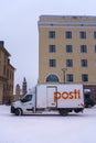 Delivery truck of the Posti group, the main Finnish postal service parked on the street in winter