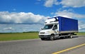 Delivery truck with white cabin and blue trailer Royalty Free Stock Photo