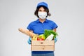 Delivery woman in face mask with food in box