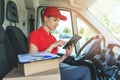 Delivery woman using digital tablet while sitting in van Royalty Free Stock Photo