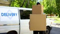 Delivery workman holding many cardboard boxes, express parcel shipment service Royalty Free Stock Photo