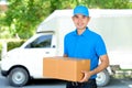 Deliveryman carrying a cardboard parcel box