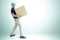 Deliveryman carrying a cardboard parcel box