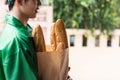 deliveryman hold bakery bag snd wait for pick up