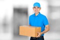 Deliveryman holding a cardboard parcel box