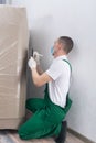 Deliveryman in a protective mask and gloves, rewrites the batch and delivery number before paperwork Royalty Free Stock Photo