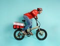 Deliveryman runs fast with electric bike to deliver pizza Royalty Free Stock Photo