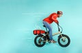 Deliveryman runs fast with electric bike to deliver pizza Royalty Free Stock Photo