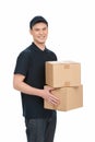 Deliveryman at work. Cheerful young deliveryman holding a box st