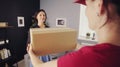 Deliverywoman giving parcel to receiver Royalty Free Stock Photo