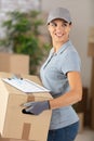 deliverywoman wearing cap holding box Royalty Free Stock Photo