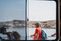 View through window of people waiting to disembark Delos Tours boat, Greece Royalty Free Stock Photo