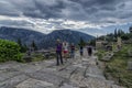 Delphi, Phocis / Greece. Tourists following the Sacred Way in the archaeological site of Delphi Royalty Free Stock Photo