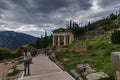 Delphi Town, Phocis / Greece - October 22, 2012: Tourists are following the Sacred Way at the famous archaeological site of Delphi Royalty Free Stock Photo