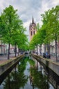 Delt canal with bicycles and cars parked along. Delft, Netherlands Royalty Free Stock Photo