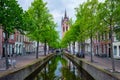 Delt canal with bicycles and cars parked along. Delft, Netherlands Royalty Free Stock Photo