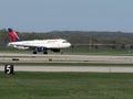 A Delta Air line plane lands on a runway