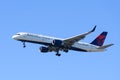 Delta Air Lines Boeing 757 landing isolated against blue sky